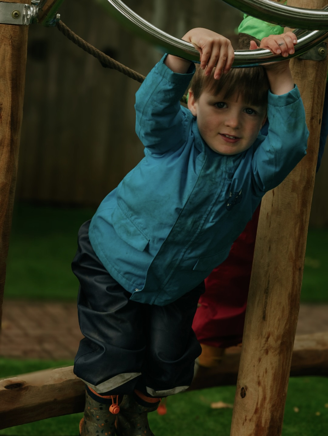 A child climbing on the outdoor play frame